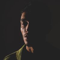 Shot 1: low-key portrait in deep shadow — Yiğit Karaalioğlu on Pexels