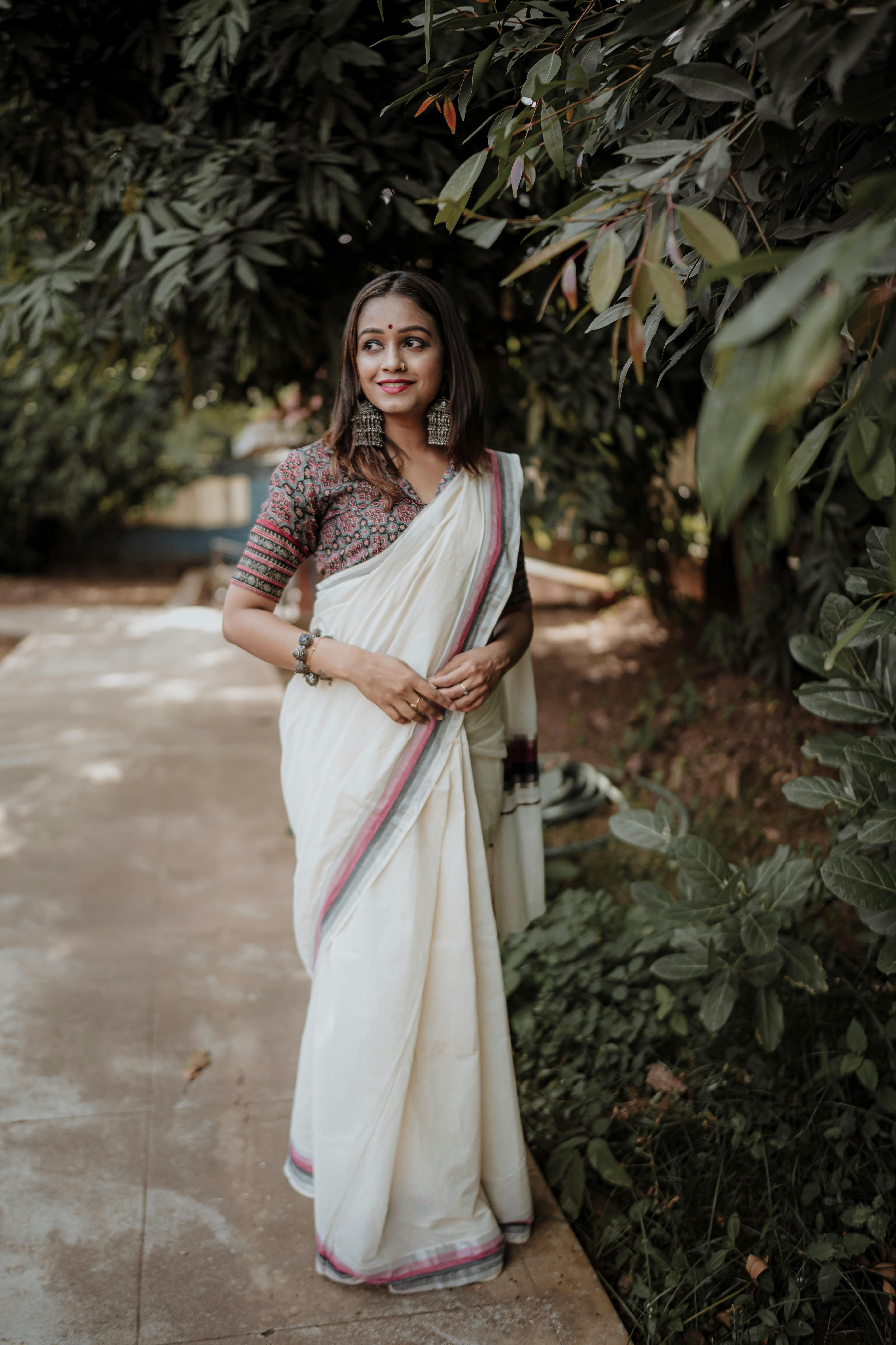Full length portrait of beauitful Indian woman in black and gold saree.  Side pose Stock Photo | Adobe Stock