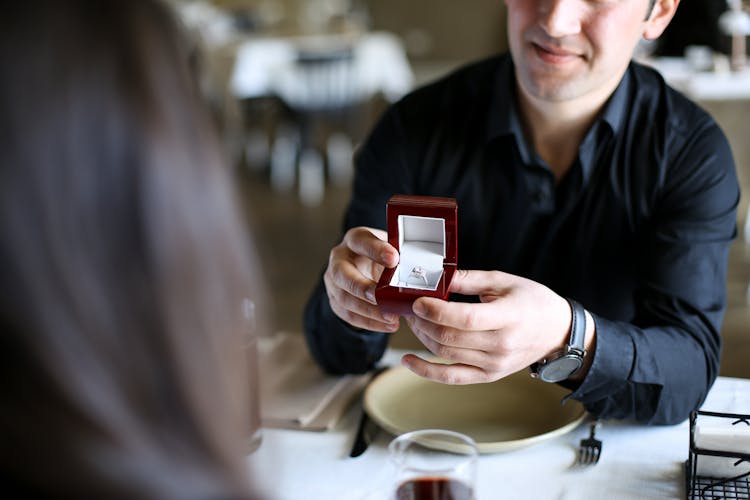 Man Proposing To A Woman At The Restaurant