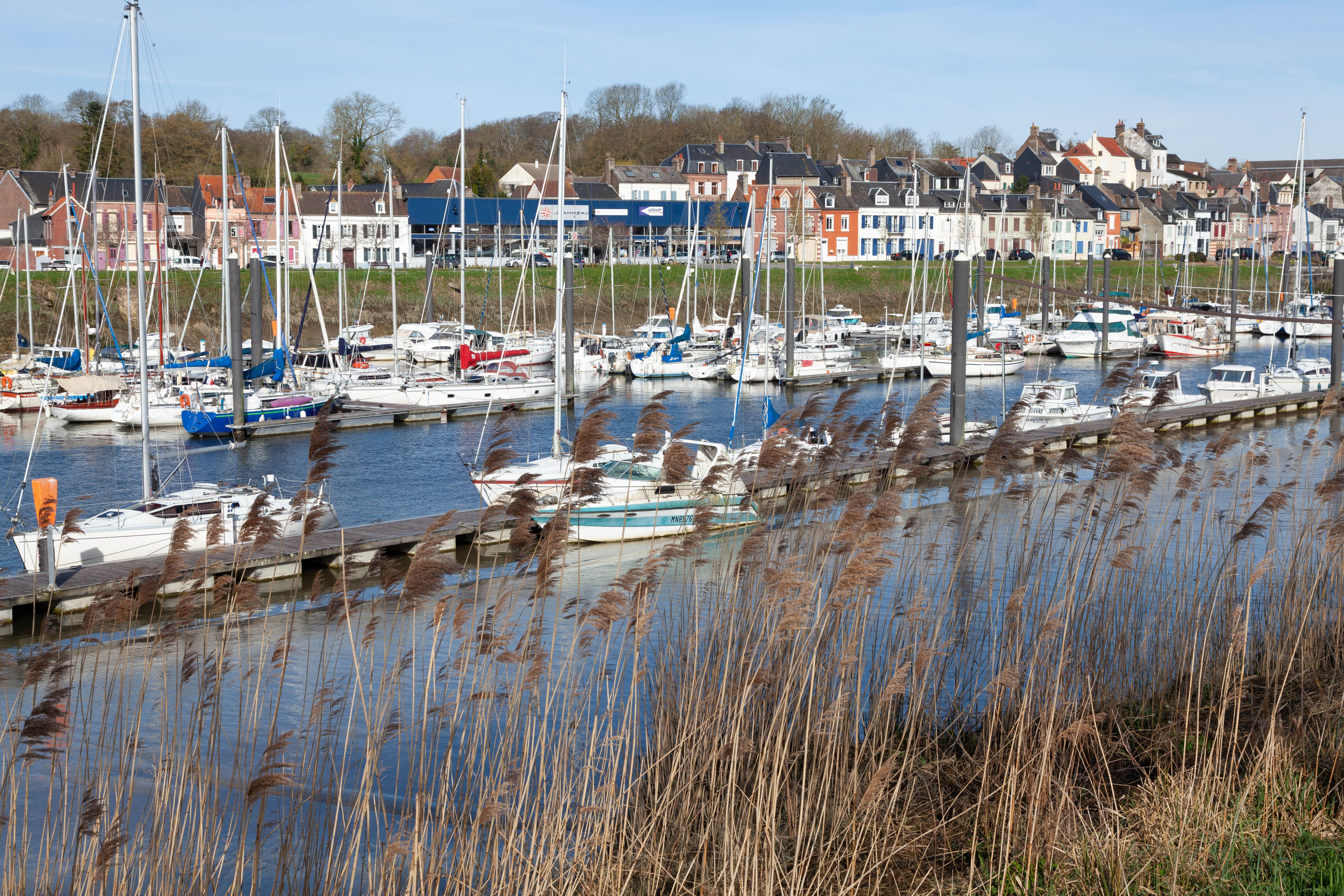 Charming coastal village harbor with sailboats and colorful houses in Saint-Valery-sur-Somme.