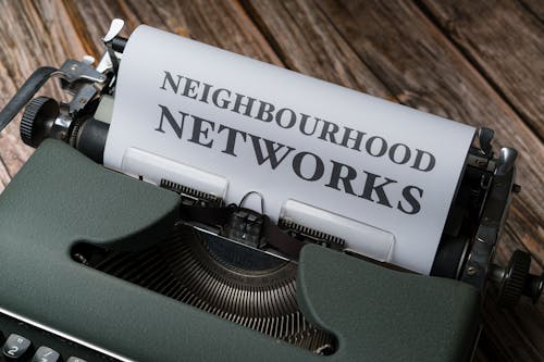 A typewriter with the words neighborhood networks on it