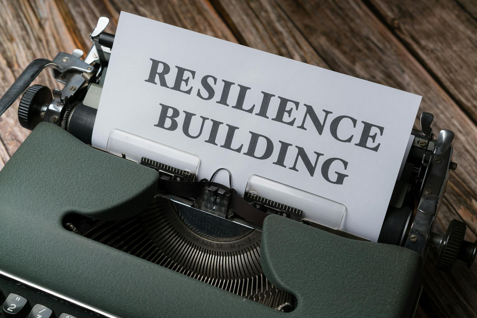 A typewriter with the word resilience building on it