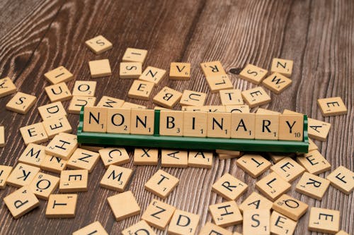 The word non - binary is spelled out with scrabble tiles