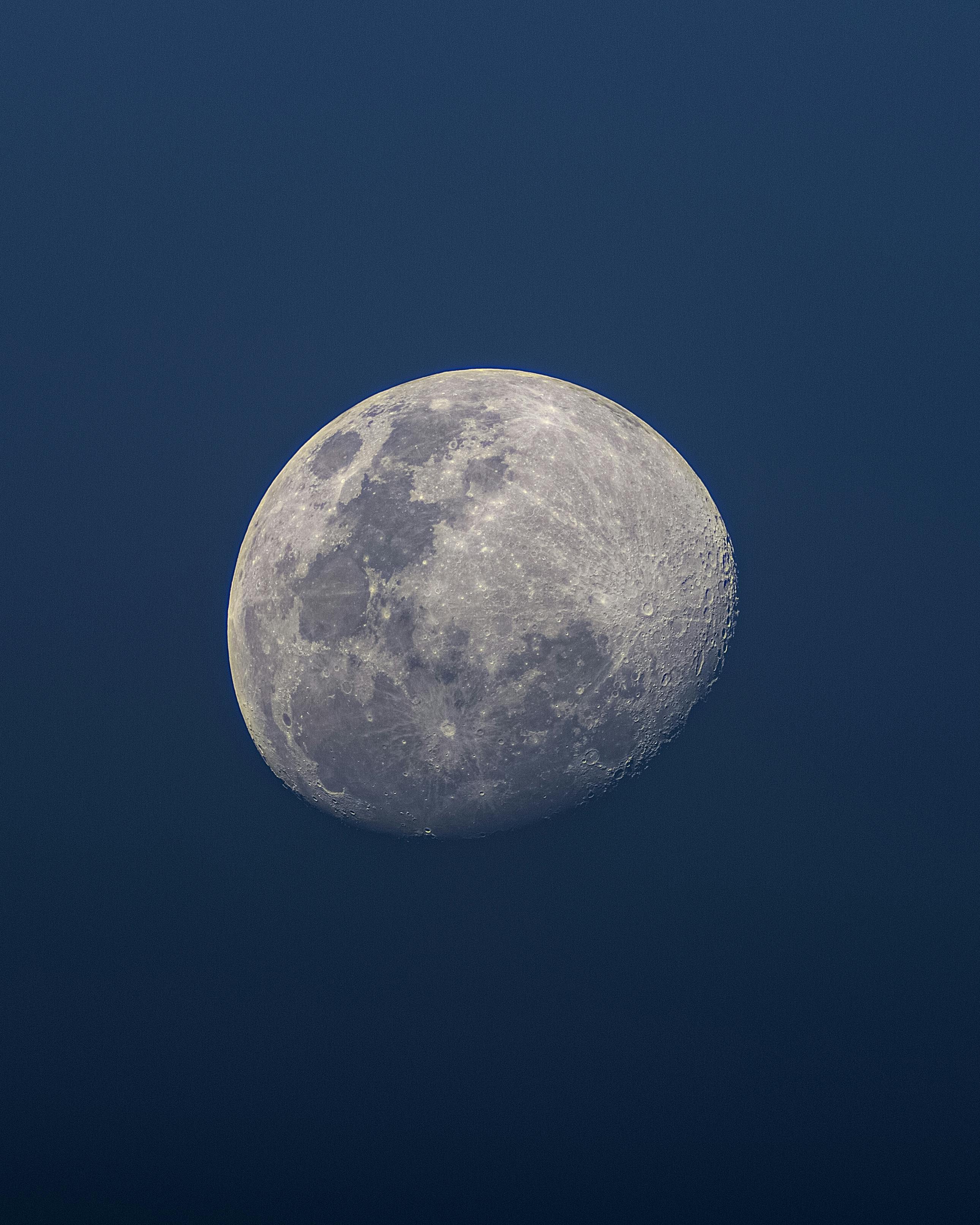 A detailed view of the full moon in the night sky, showcasing its craters and luminous presence.