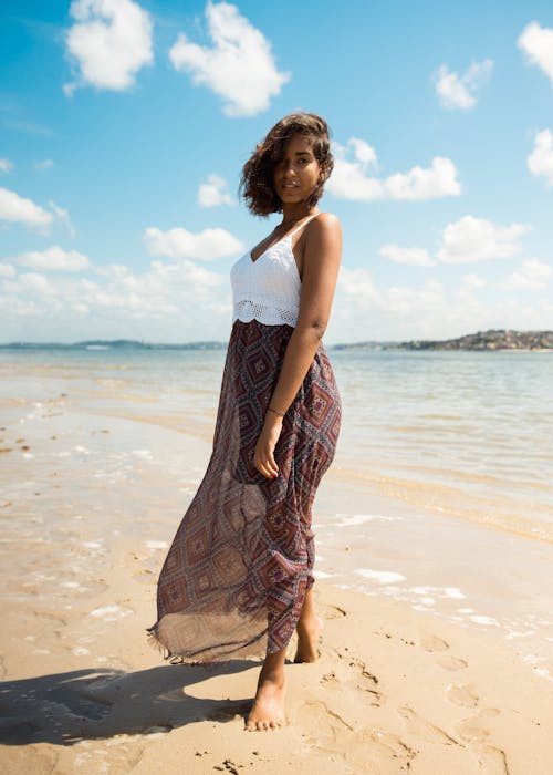 Free Woman Standing on Shore Stock Photo