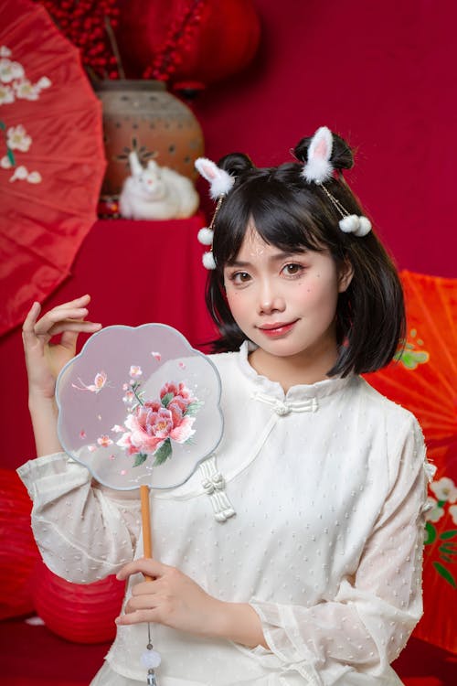 Smiling Woman with Traditional Fan