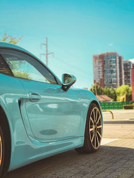 Close-up of a luxury sports car parked on a sunny day in the city.