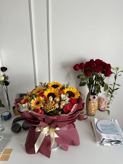 Red and Yellow Bouquets on a Desk