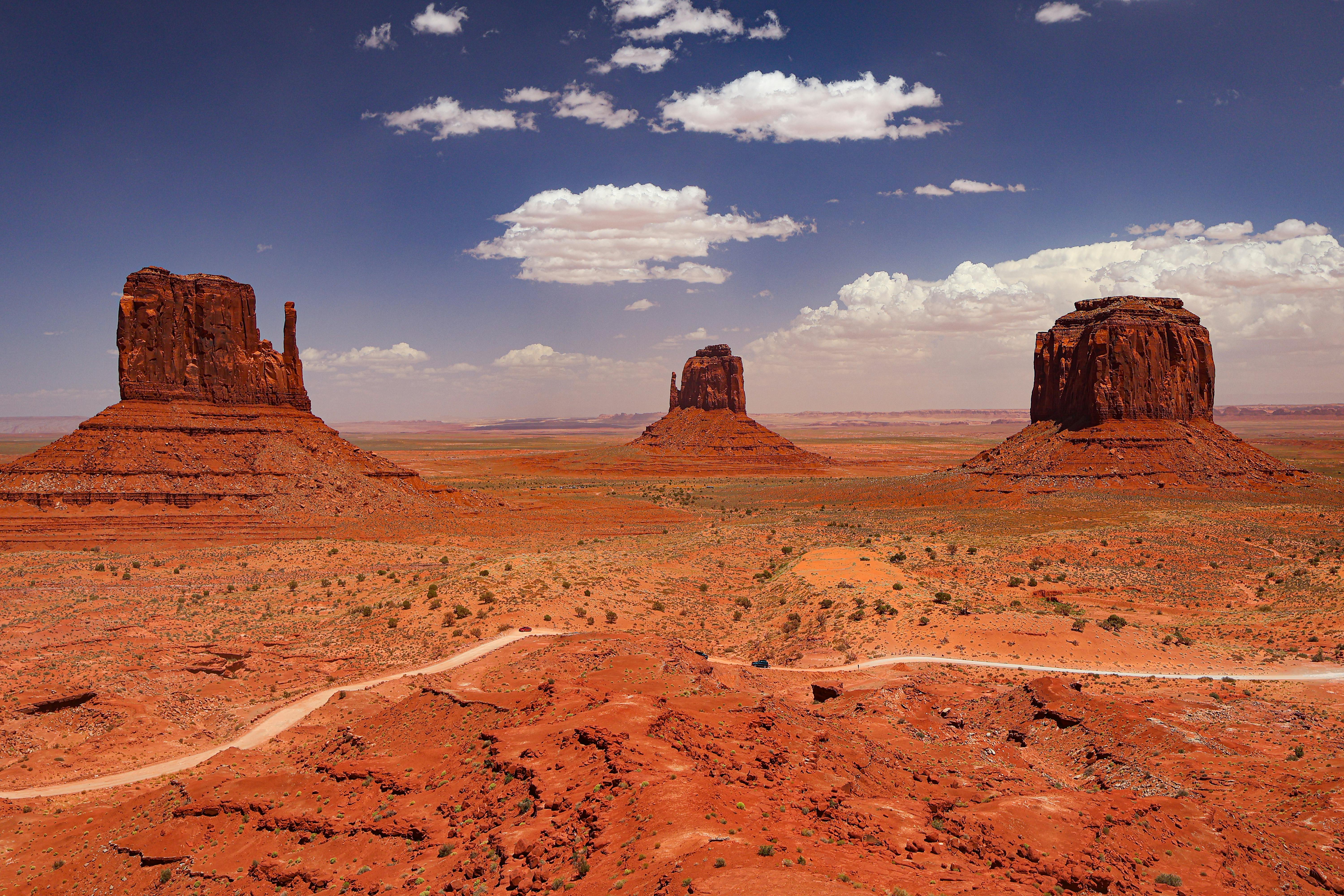 Breathtaking view of Monument Valley's iconic red rock formations under a bright blue sky in Arizona, USA.