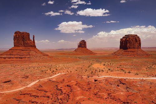 Free Breathtaking view of Monument Valley's iconic red rock formations under a bright blue sky in Arizona, USA. Stock Photo