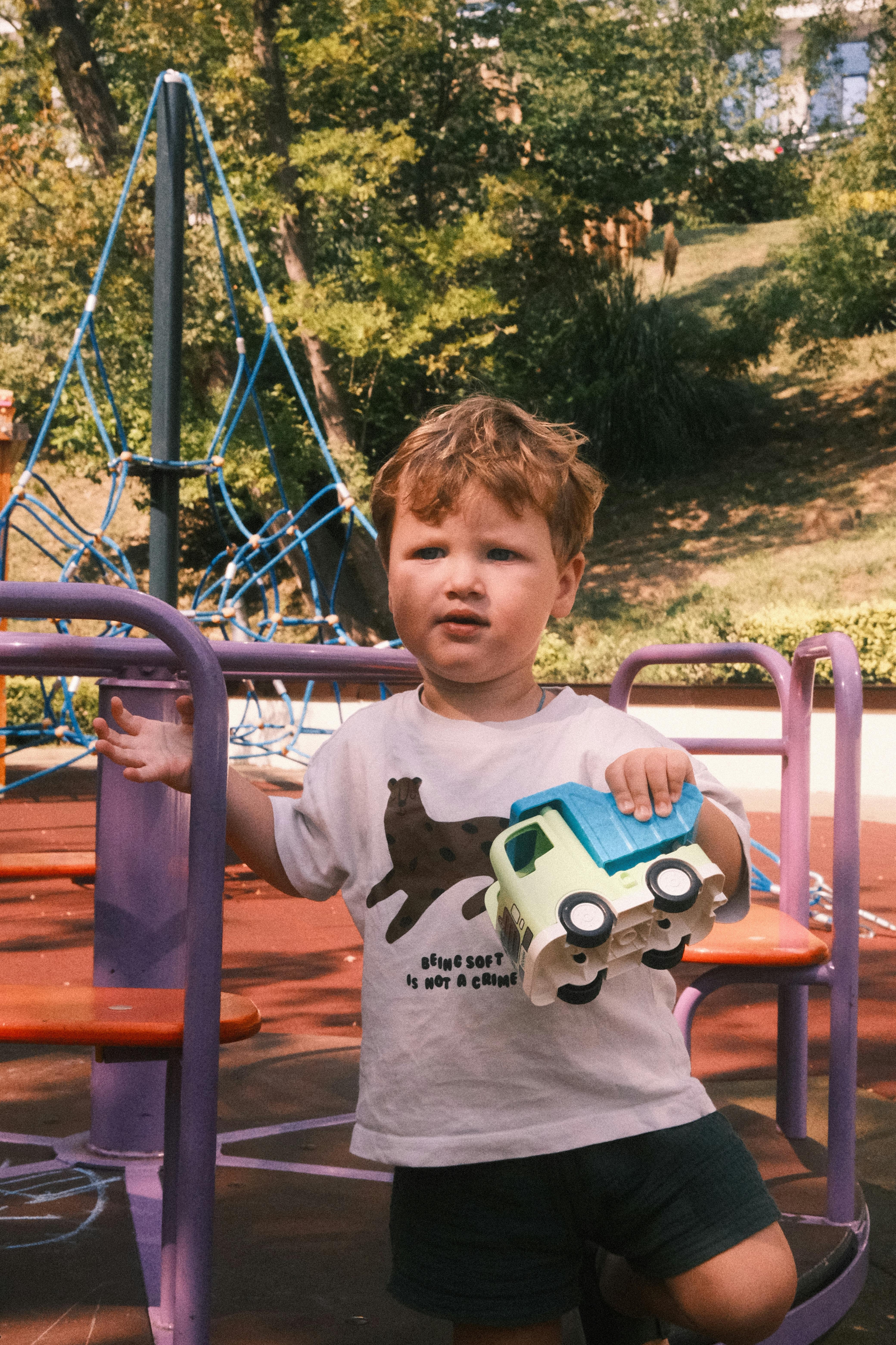 child with a car on the playground