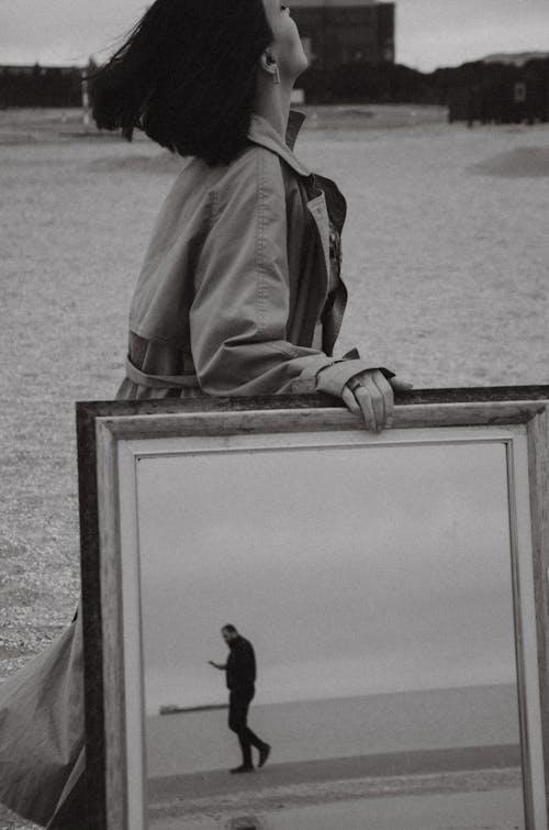Woman Walking on the Beach with a Mirror