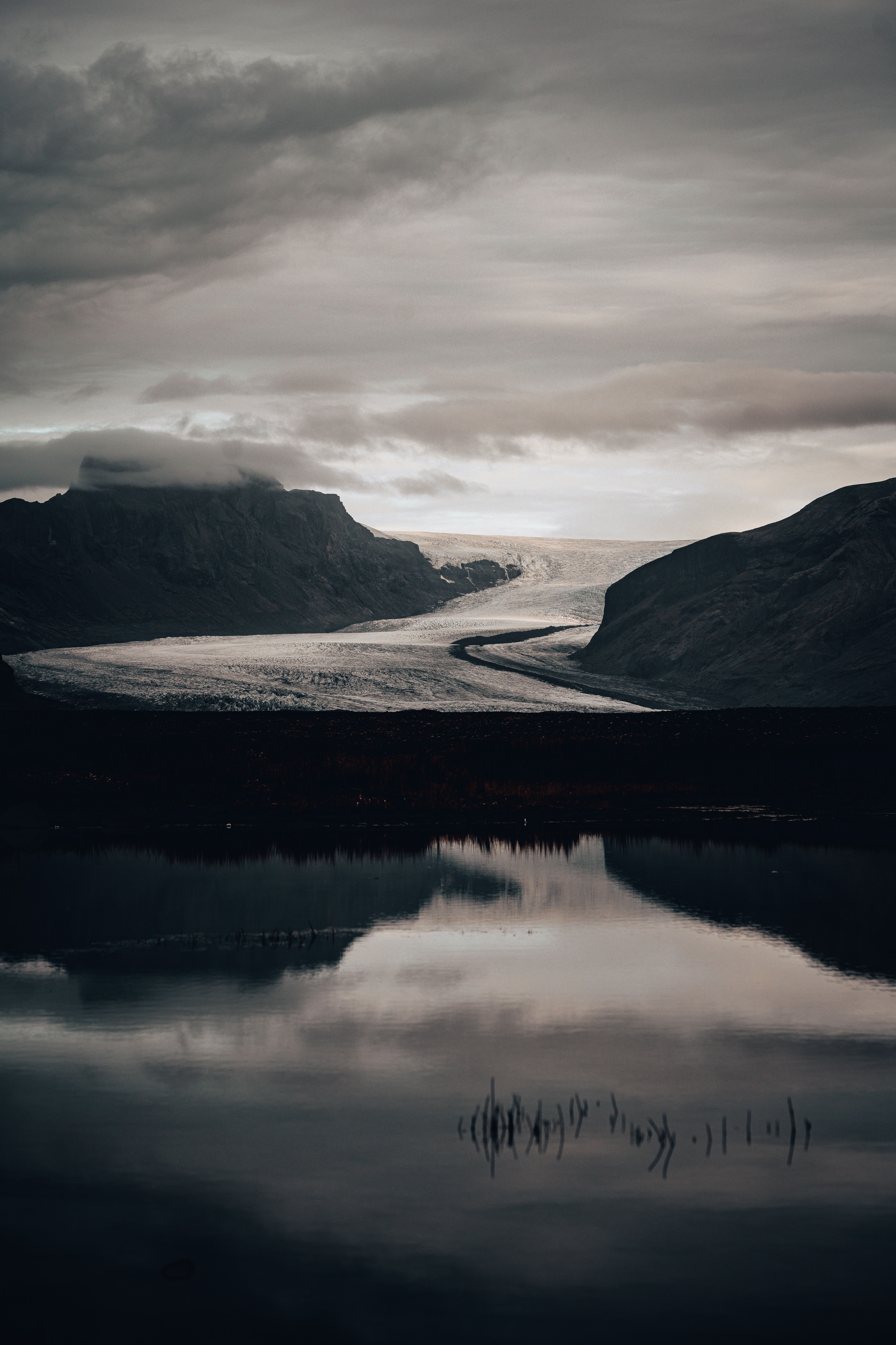 Landscape of a Body of Water and Mountains under a Cloudy Sky · Free ...