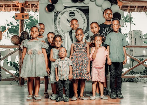 Free A Group of Children Posing for a Photo at a Party Stock Photo