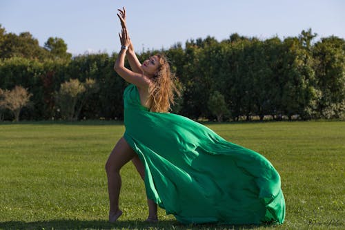 Woman Standing in Green Elegant Dress on Meadow