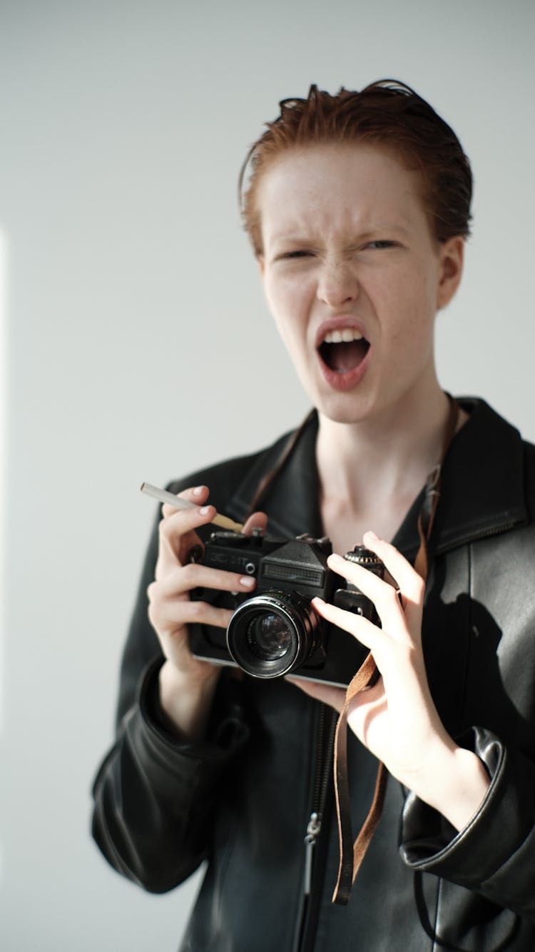 Screaming Person Holding Analog Camera And Cigarette