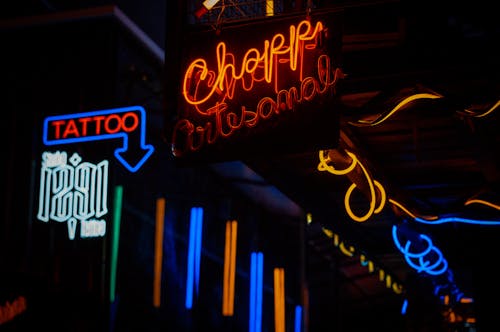 Free Illuminated Neon Signs on the Walls in City Stock Photo