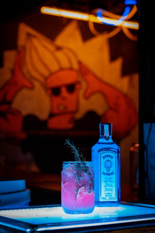 Close-up of an Alcoholic Drink and a Bottle Standing on a Bar Counter