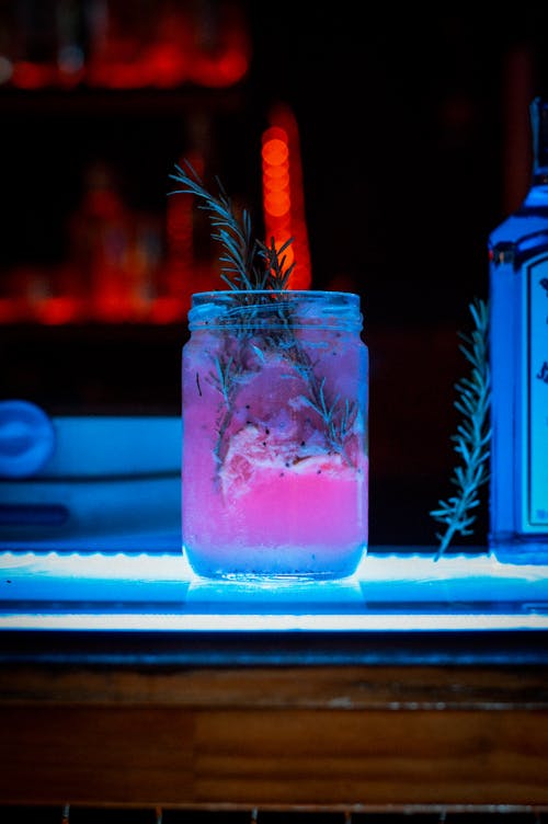 Close-up of an Alcoholic Drink and a Bottle Standing on a Bar Counter 