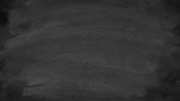 A high-resolution image of a blank blackboard showing chalk stains, ideal for educational themes.