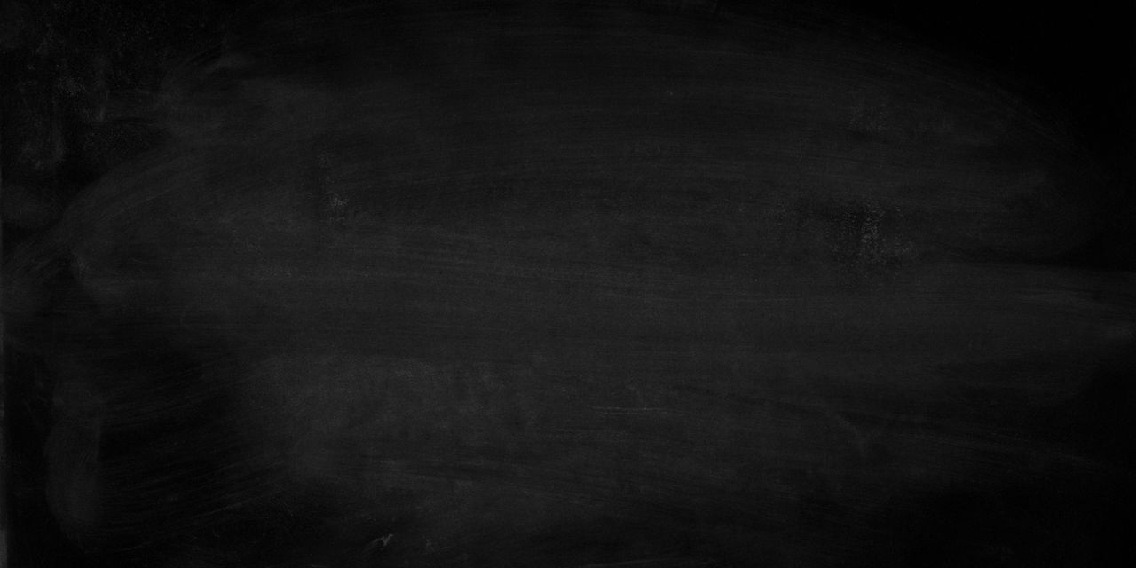 A simple black chalkboard displaying erased chalk marks.