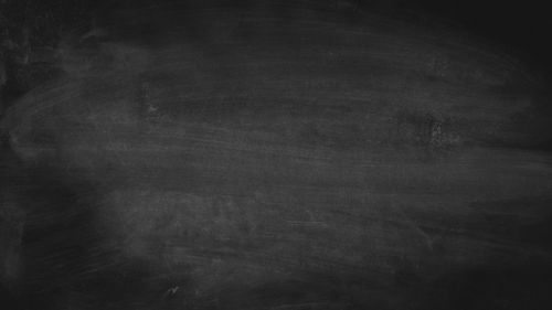 Free A blank chalkboard background with visible texture, ideal for design projects. Stock Photo