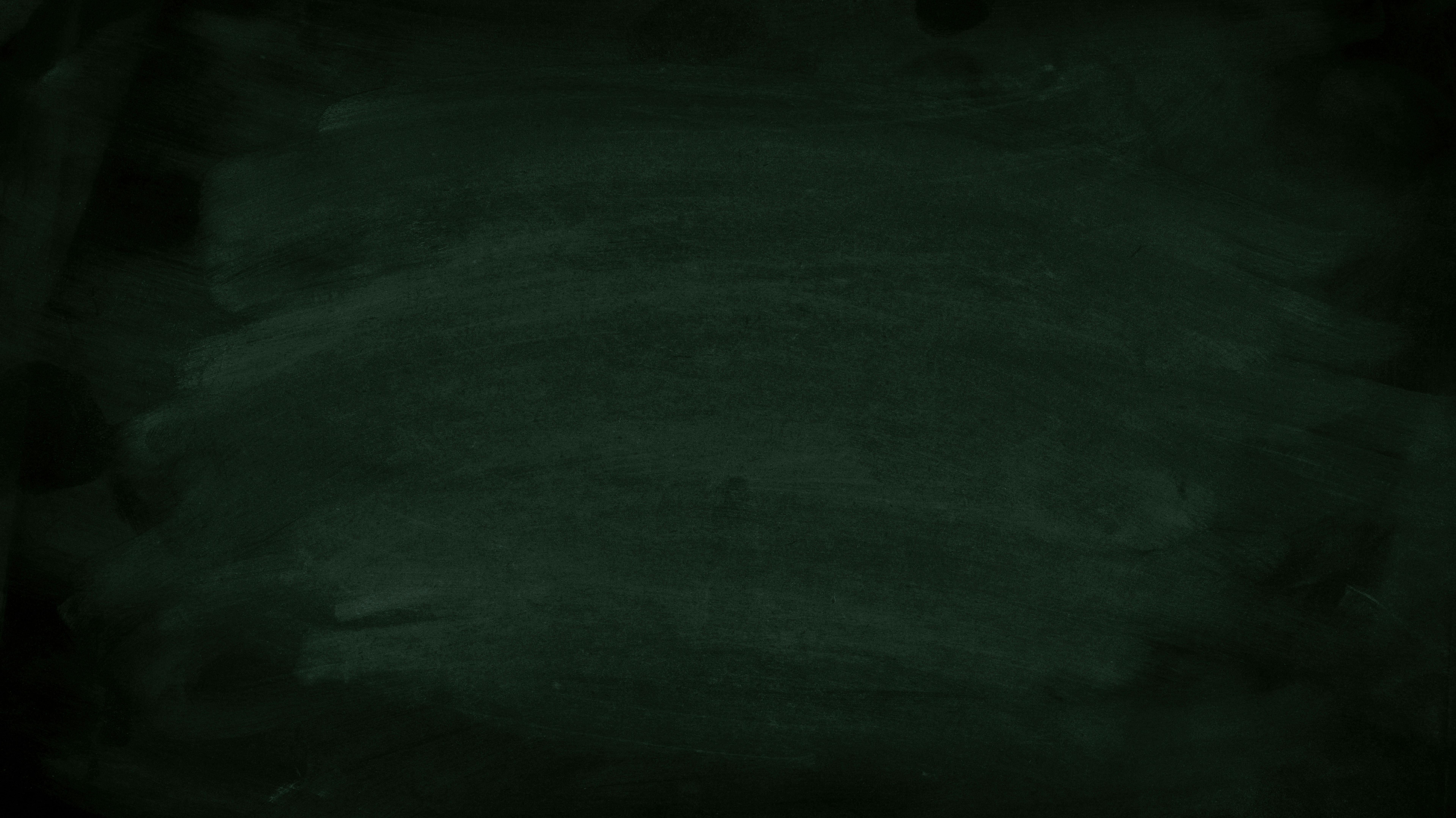 Free Dark green chalkboard with subtle chalk marks for background use. Stock Photo