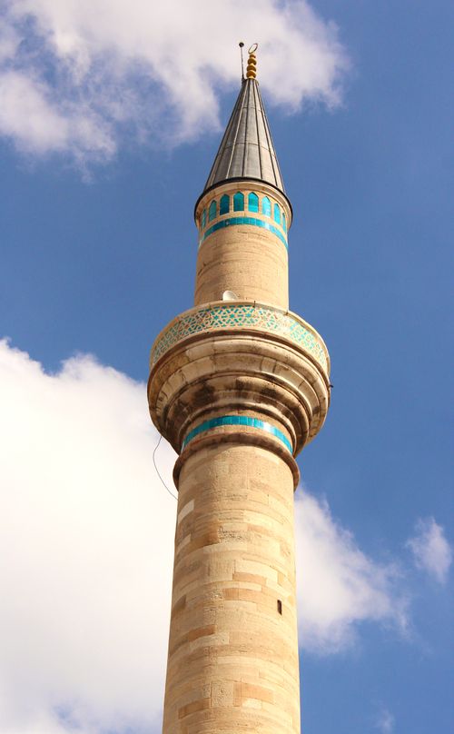 Free Vertical shot of a majestic mosque minaret against a clear, blue sky. Stock Photo