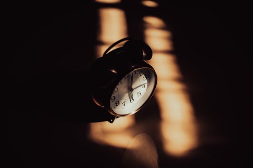 Old Style Alarm Clock in a Dark Room