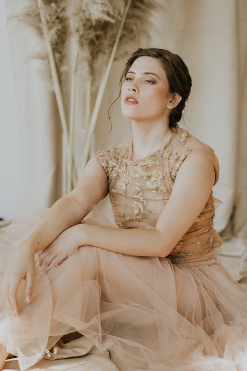 Young Woman Posing in a Beige Tulle Dress