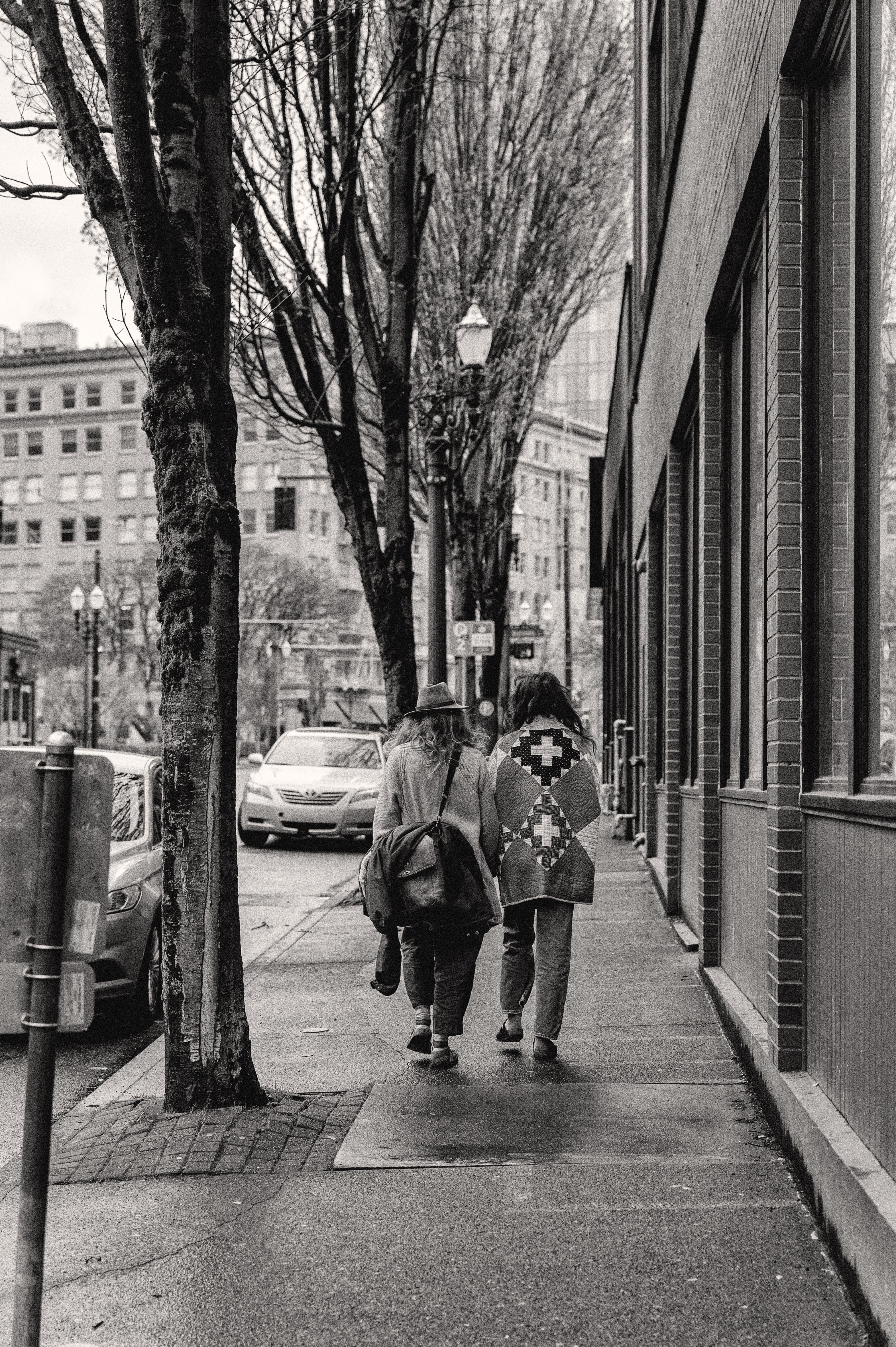 Black and White Photo of a Couple Walking on a Street · Free Stock Photo