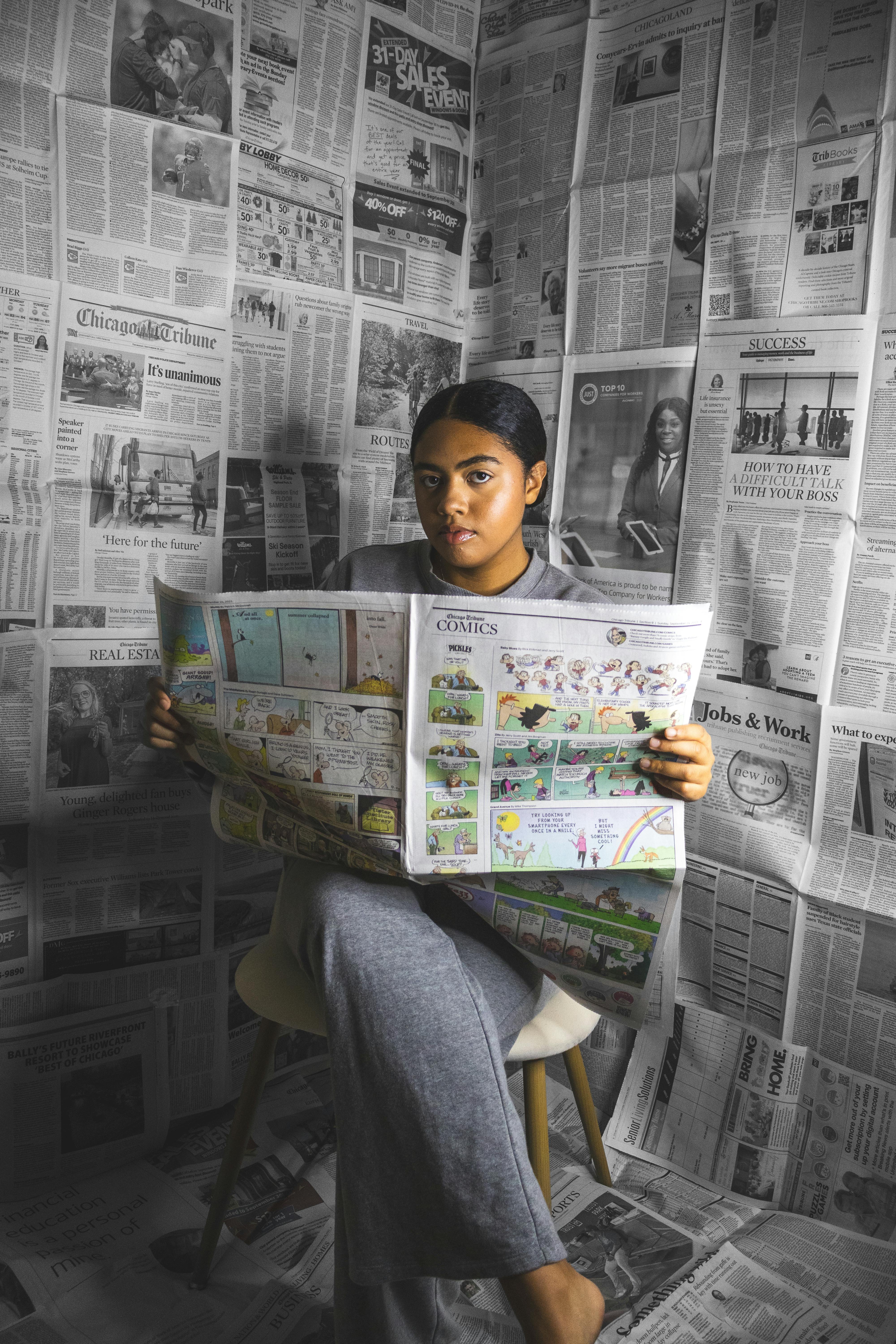 woman among newspapers