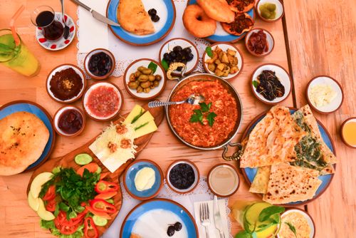 Free A vibrant Mediterranean meal featuring diverse dishes on a rustic table, perfect for a feast. Stock Photo
