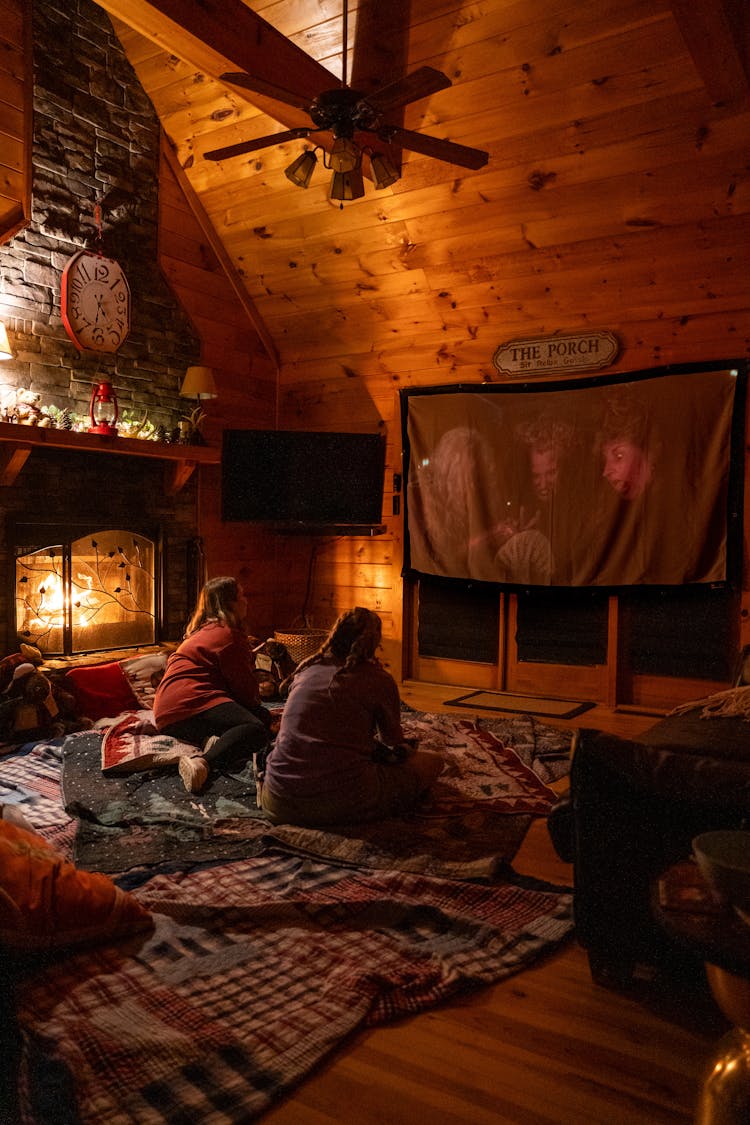 Two Girls Watching TV In A Cozy Living Room