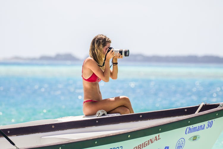 Woman In Bikini Taking Photos From A Boat