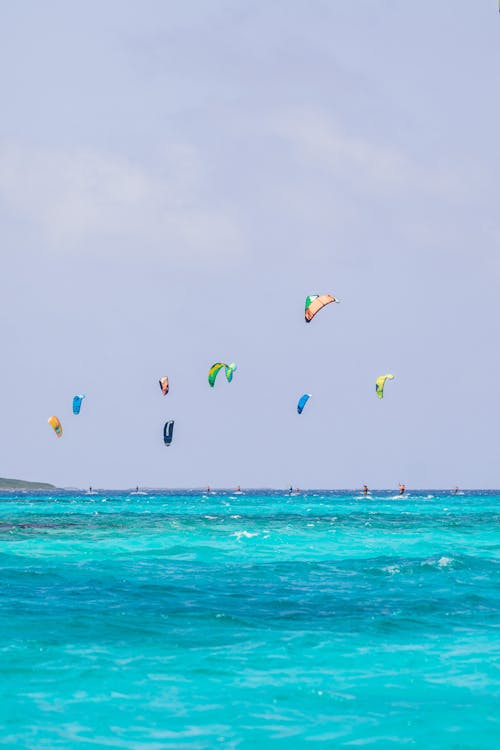 Sky Over the Turquoise Ocean Dotted with Power Kites