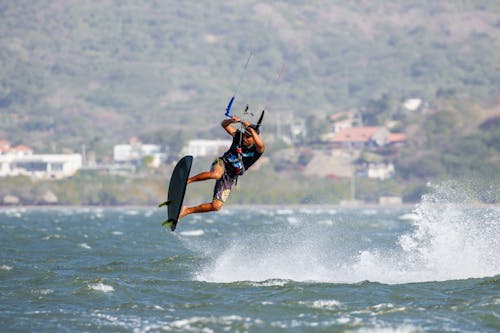 Kiteboarder on a Surfboard With Fins Above the Water