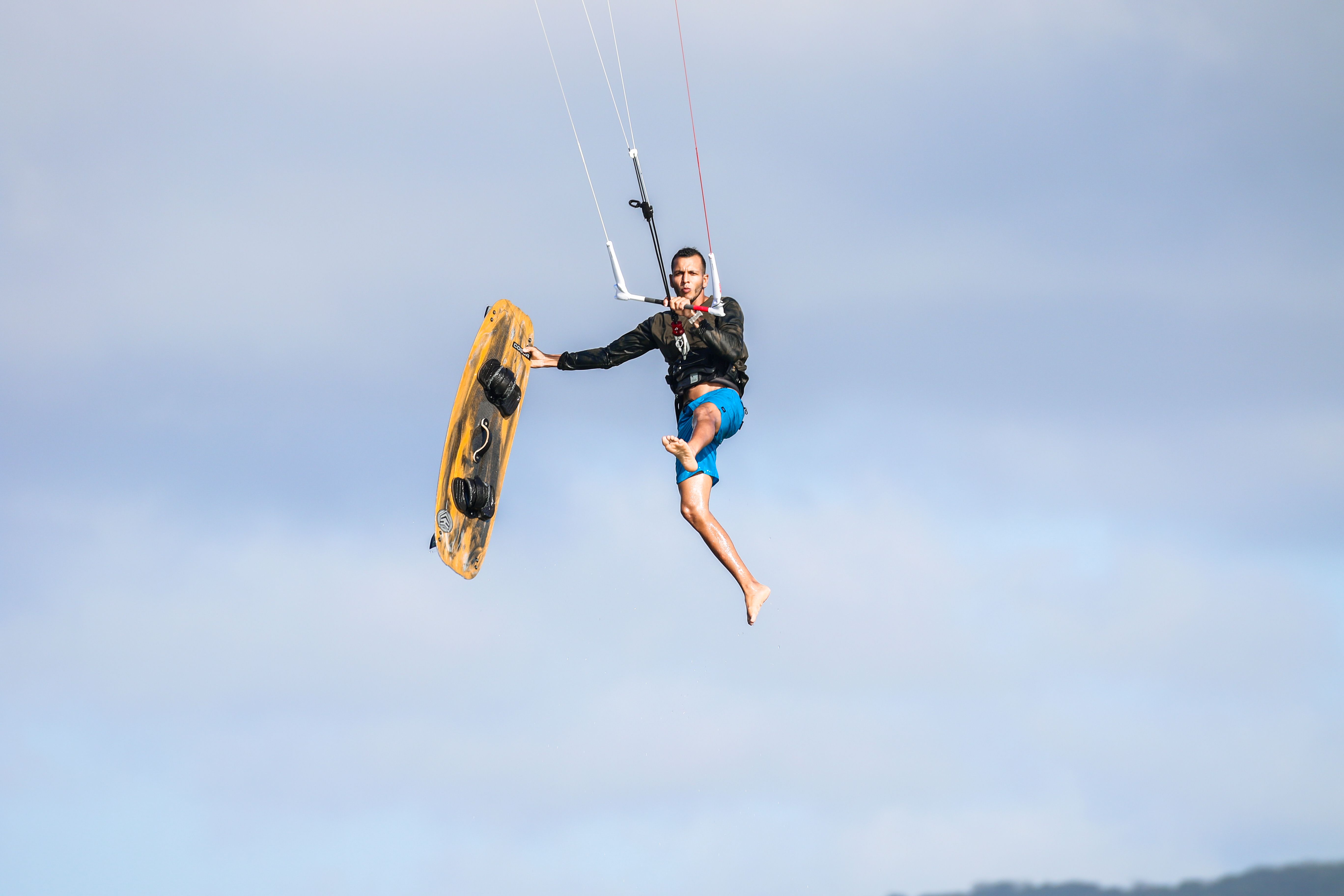 Man Jumping on a Kiteboard Against the Sky · Free Stock Photo