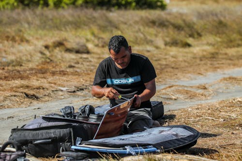 Man Repairing a Kite
