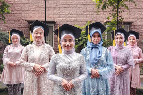 Smiling Graduates in Traditional Clothing