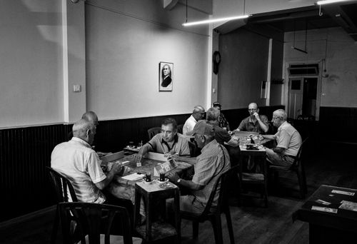 Free Senior men gathered in a Turkish café playing cards, capturing a slice of leisure in Istanbul. Stock Photo