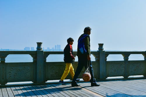 Father and Son Walking on Promenade