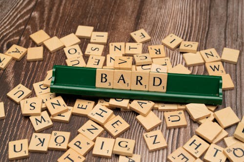 The word bard on a wooden table with scrabble tiles