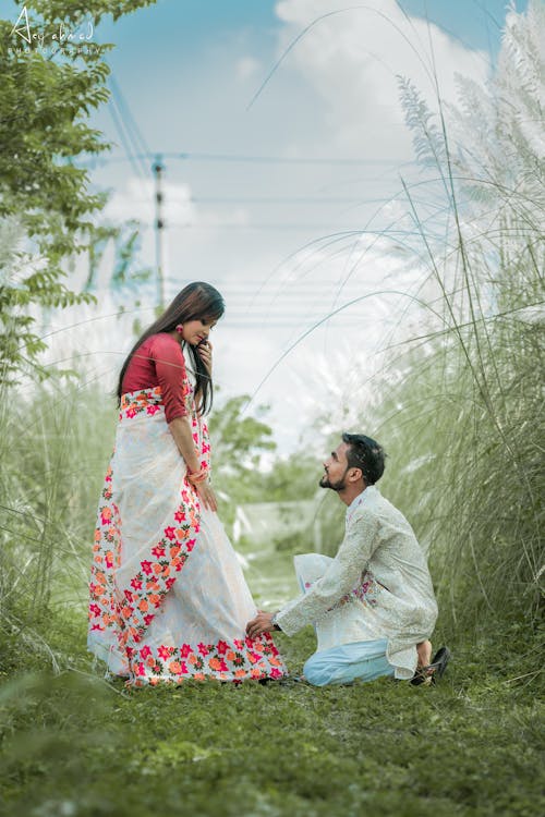 Woman and Man in Traditional Clothing on Engagement