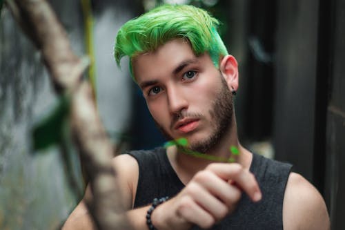 Free Man Wearing Tank Top With Green Hair Stock Photo