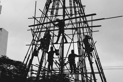 Workers on Scaffolding in Black and White