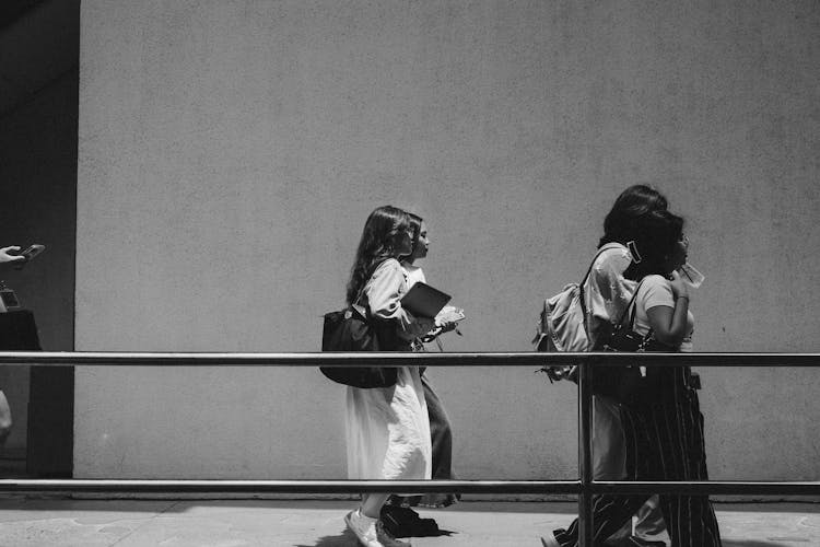 Group Of Women Walking And Talking In The Corridor