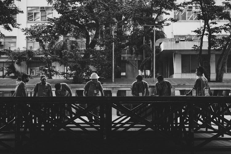 Group Of Workers Discussing Project With Foreman