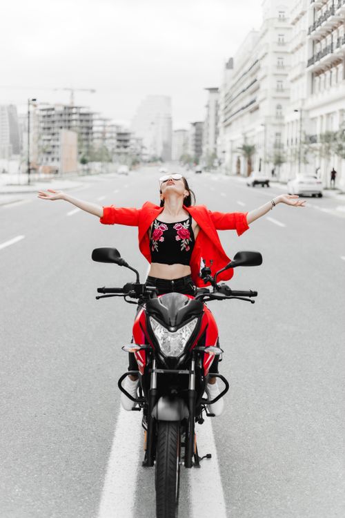 Free Confident woman enjoys the open road in Baku, Azerbaijan on a motorcycle. Stock Photo