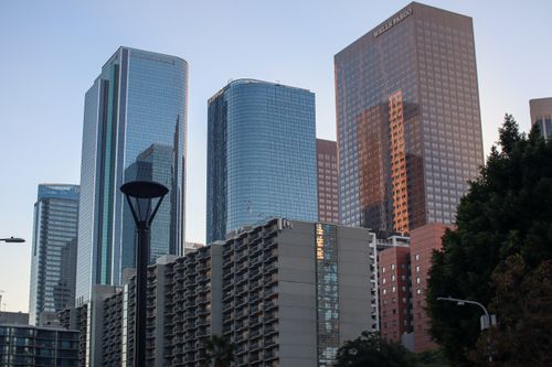 Free Sleek, modern skyscrapers in downtown Los Angeles at dusk reflecting urban architecture. Stock Photo